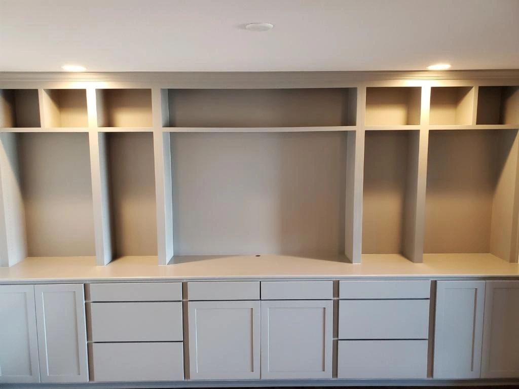 Light grey built-in entertainment cabinet and open shelves
