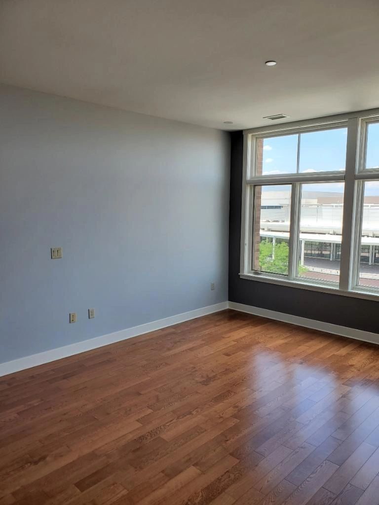 Empty room with light grey and charcoal walls and white trim